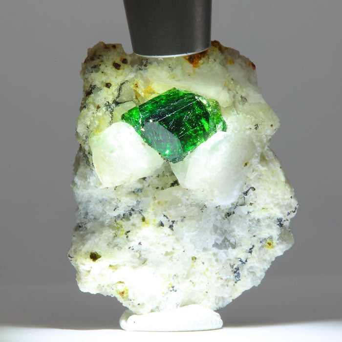 green tourmaline crystal in white matrix with strong color