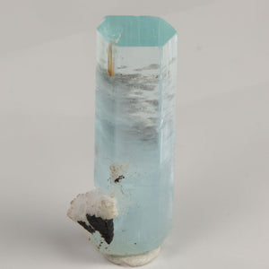 Angled view of Pakistani aquamarine revealing its flat hexagonal termination and natural blue color.
