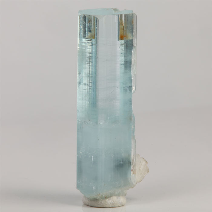 Side view of 10.68 gram aquamarine showing clear hexagonal faces and fine horizontal growth lines.