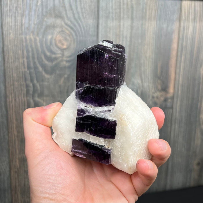 Purple Scapolite crystal on a white background