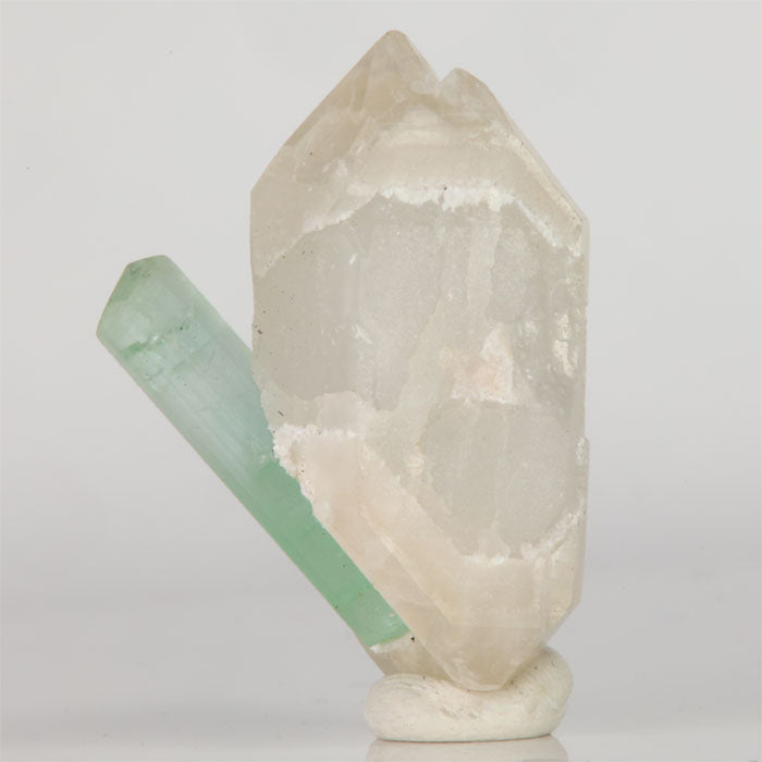Mint-green Tourmaline crystal alongside double-terminated Quartz from Mavi Pegmatite, Afghanistan.