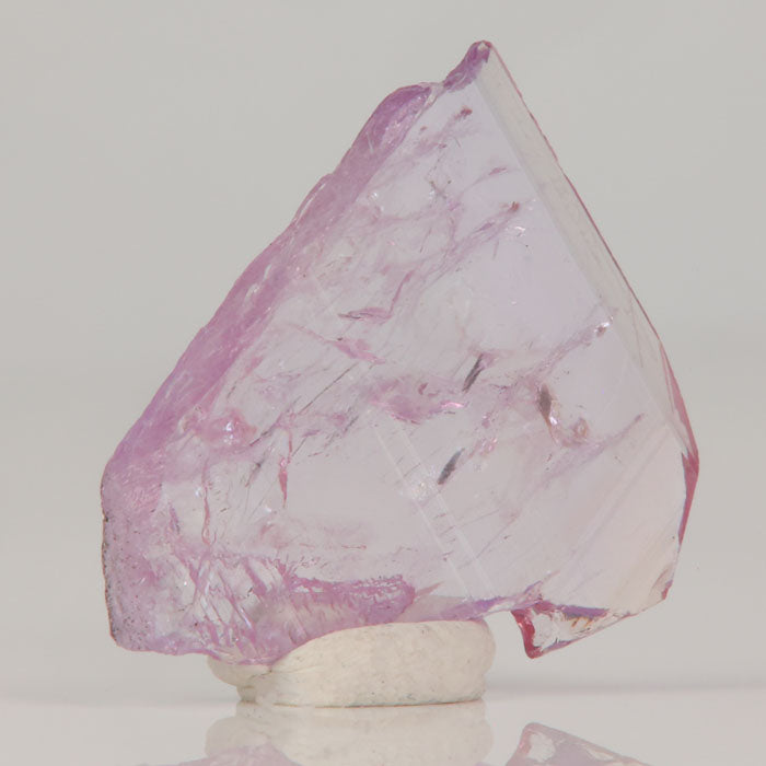 Thin magnesio-axinite crystal displaying internal veils and natural luster