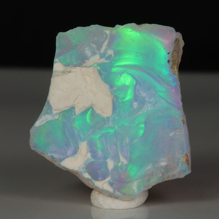 Ethiopian opal specimen with green, red, and violet play-of-color