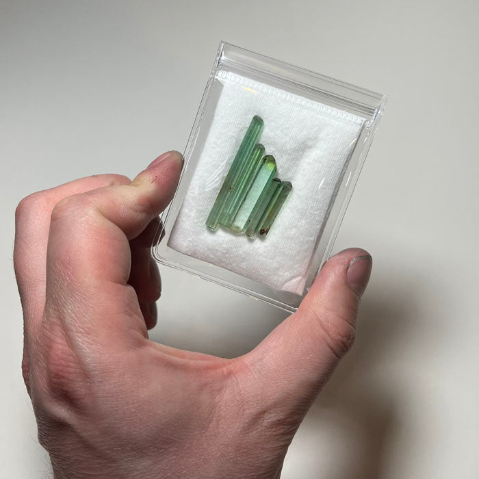 elongated green tourmaline crystals varying sizes mineral specimen set