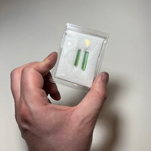 two bright green tourmaline rods with natural terminations