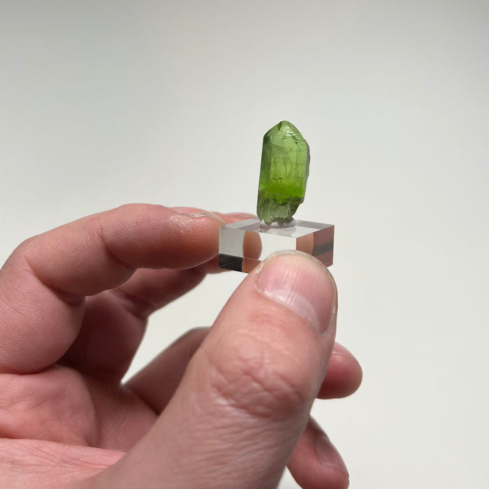 Natural olivine peridot crystal showing vivid green color and inclusions