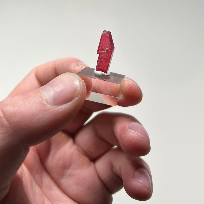 Bright pink rhodonite crystal specimen from Brazil with natural structure