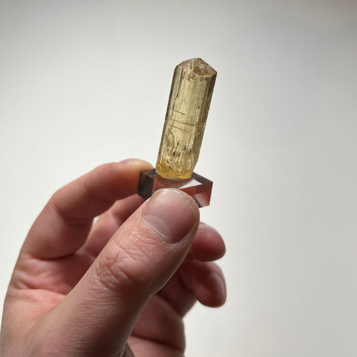 Natural scapolite specimen showing elongated prismatic form and termination
