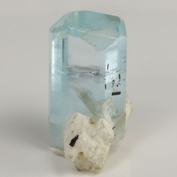 Front view of 13.63 gram aquamarine specimen with a broad hexagonal termination and white mineral matrix near the base.