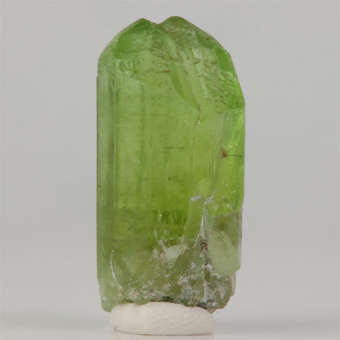 Pakistani peridot crystal with elongated prismatic form and natural termination