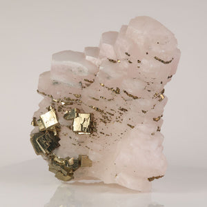 pale pink calcite with pyrite inclusions cluster
