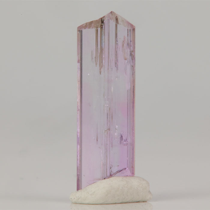 Natural pink tanzanite specimen with slender shape and clarity