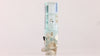 Aquamarine specimen with prominent black mineral inclusion near the base and delicate blue coloration.
