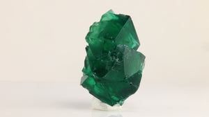 Side view of Rogerley Mine fluorite showing transparent green crystal edges, intergrown formations, and natural surface textures.