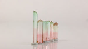 raw tourmaline crystal group with green and pink tones