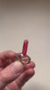 Triclinic rhodonite crystal with saturated pink color and smooth luster