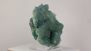blue green fluorite cluster shown in hand for scale