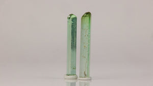 natural green tourmaline rods displayed as a collector pair