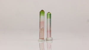 raw tourmaline crystals pair green and pink tones display specimen