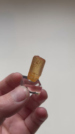 Brazilian topaz specimen with warm orange hues and broad crystal face