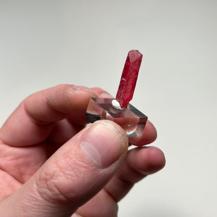 Elongated pink rhodonite crystal specimen from Brazil with slender form