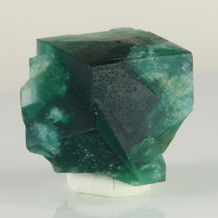 Deep green Rogerley Mine fluorite crystal weighing 37.34 grams with sharp cubic faces and smaller intergrown crystals.