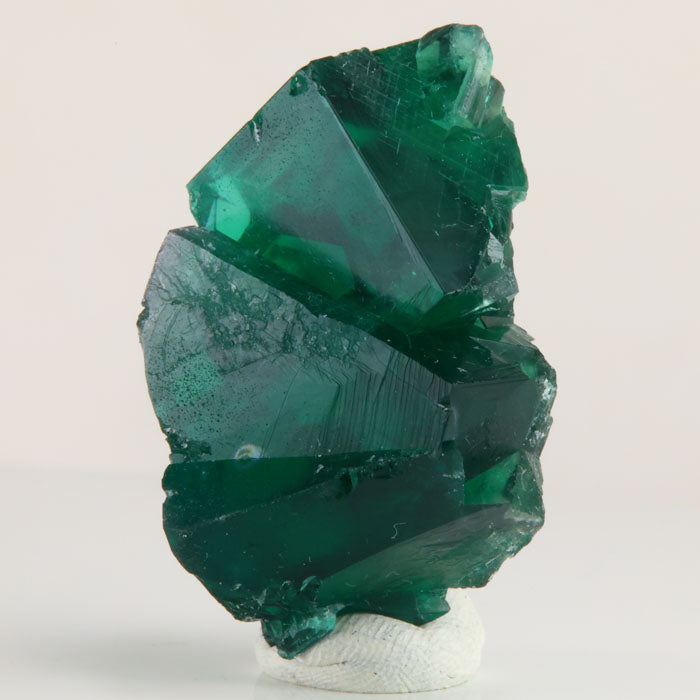 Deep emerald-green Rogerley fluorite crystal cluster weighing 40.05 grams with overlapping cubic crystals and sharp geometric faces.