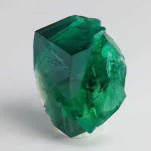 Deep emerald-green Rogerley Mine fluorite twin crystals displaying sharp cubic faces and gemmy translucency.