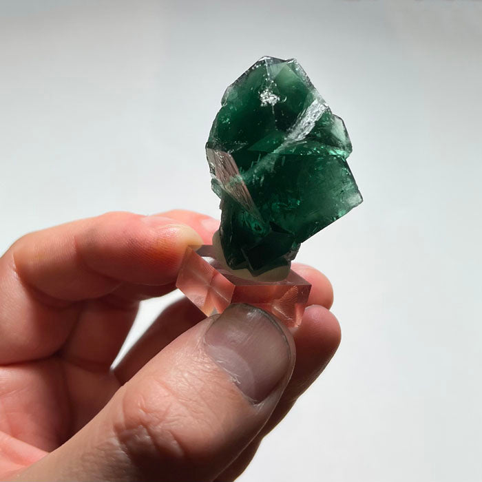 Reverse view of Rogerley fluorite with interlocking twinned crystals, parallel surface striations and contrasting white mineral deposits.