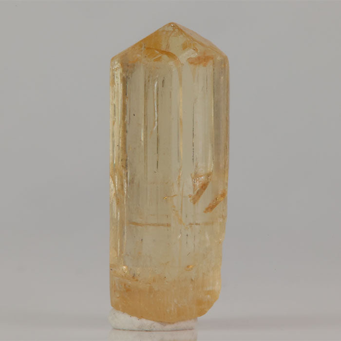 Tanzanian scapolite crystal with translucent body and honey yellow tones