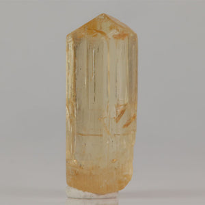 Tanzanian scapolite crystal with translucent body and honey yellow tones