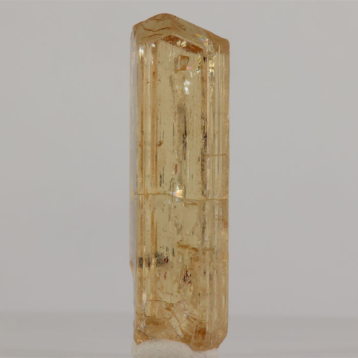 Tanzanian scapolite crystal with vertical striations and internal inclusions