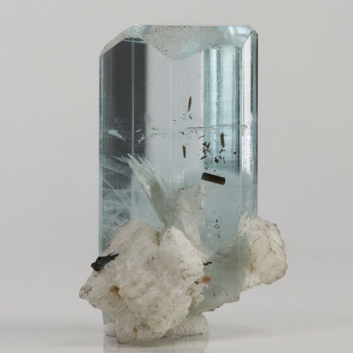 Aquamarine crystal from Shigar Mine Pakistan featuring dark needle-like inclusions suspended within transparent blue beryl.