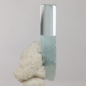 Pale blue aquamarine crystal on white matrix from Shigar Mine Pakistan with a black mineral inclusion.