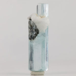 Natural aquamarine thumbnail specimen from Skardu Valley displaying a slender crystal with terminations at both ends.