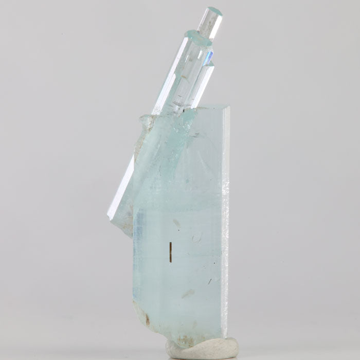 Side view of light blue aquamarine from Skardu Valley featuring overlapping prismatic crystals and natural growth details.
