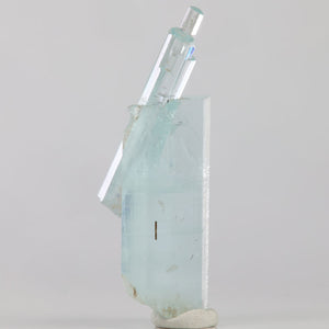Side view of light blue aquamarine from Skardu Valley featuring overlapping prismatic crystals and natural growth details.