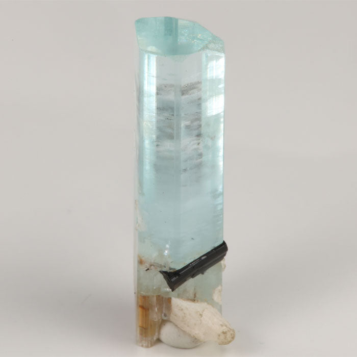 Side view of transparent Pakistani aquamarine showing internal growth lines and mineral inclusions.