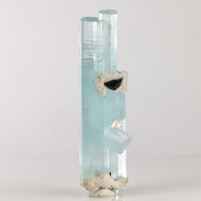 Tall aquamarine crystal cluster from Shigar Mine Pakistan with two parallel blue crystals and attached white matrix.