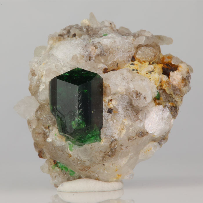 green tourmaline crystal embedded in natural matrix