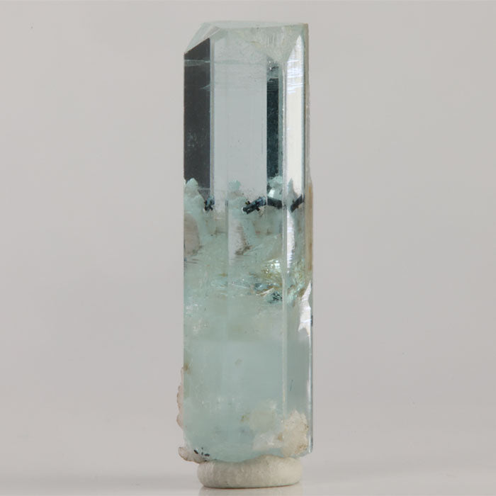 Transparent icy-blue aquamarine crystal from Shigar Mine Pakistan with a natural hexagonal termination and white matrix.
