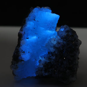 Blue prehnite crystal cluster with electric blue fluorescence