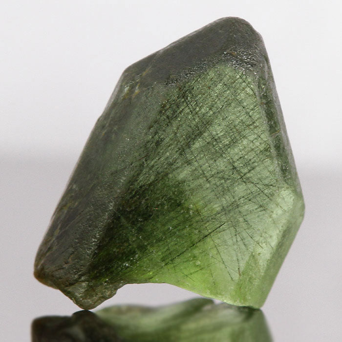 Peridot with ludwigite inclusions crystal